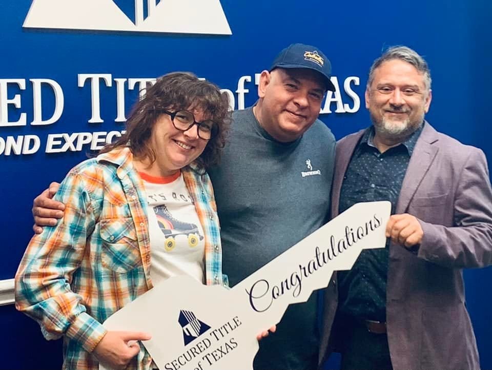 Lorne McMillan with clients holding a congratulations key on closing day